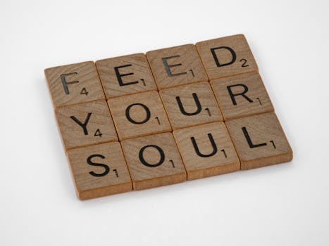 Close-up of Scrabble tiles spelling 'Feed Your Soul' on a white background.