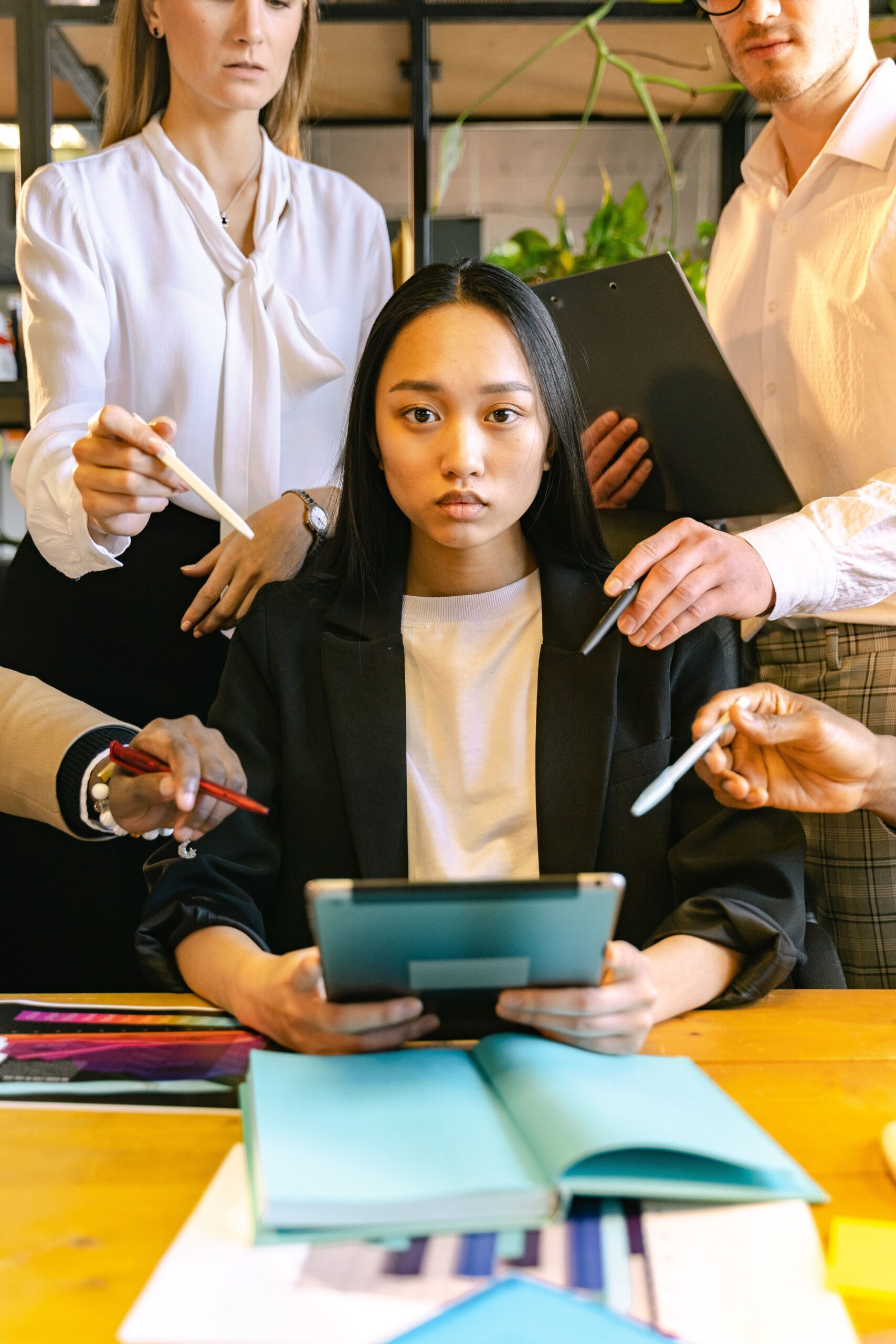 Líder atendiendo múltiples solicitudes de su equipo durante una reunión de trabajo.